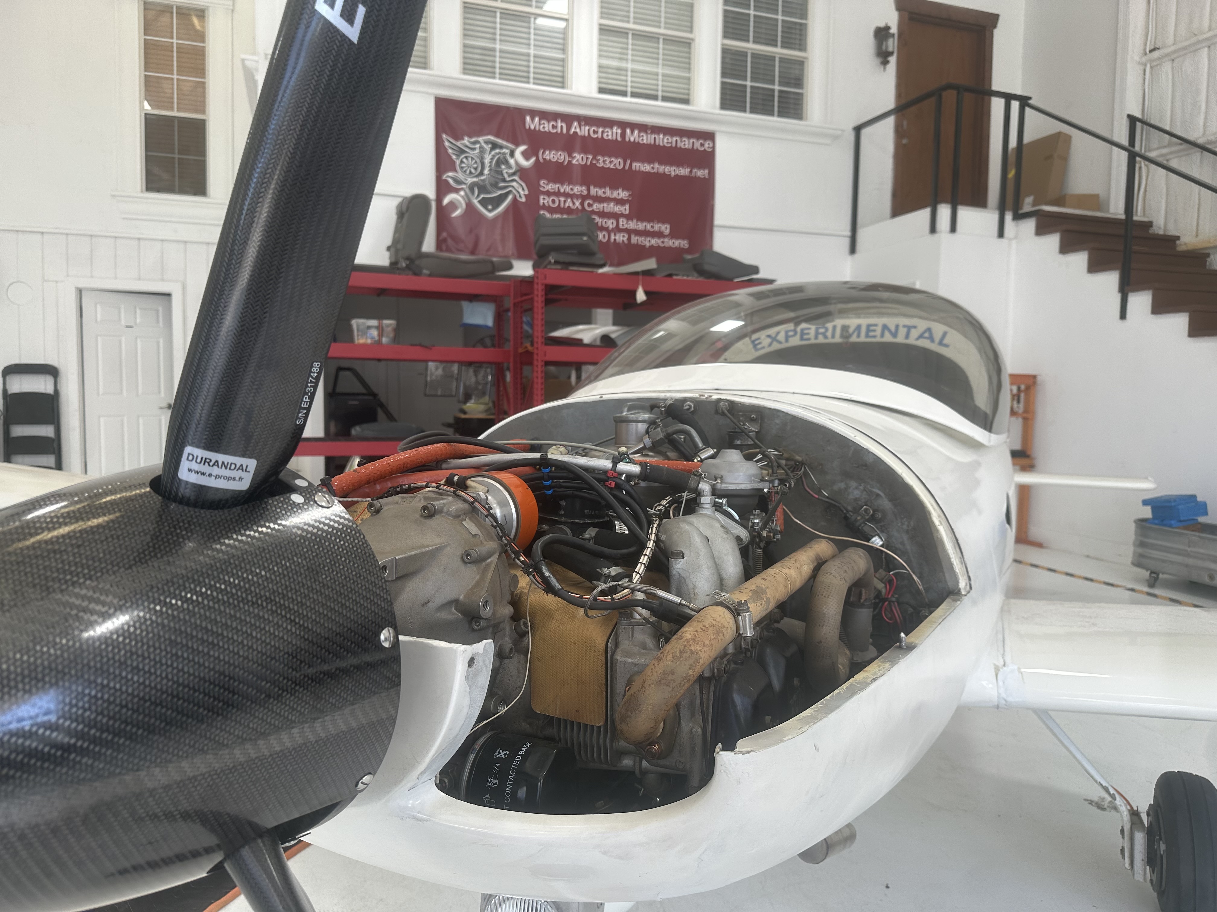 Pulsar XP with its Rotax engine and carbon-fiber propeller exposed in the Mach hangar
