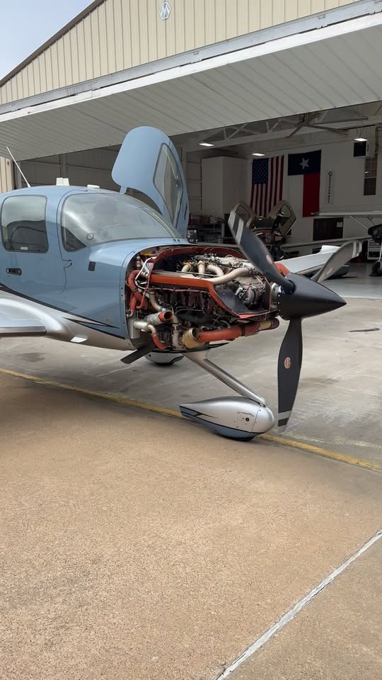 Cirrus SR22 with cowling removed for engine access during maintenance at Mach Aircraft Maintenance